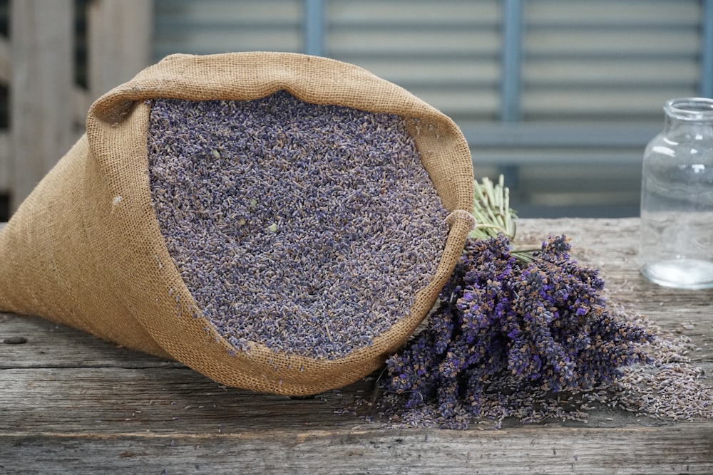 a bag of lavender next to a bunch of lavender flowers