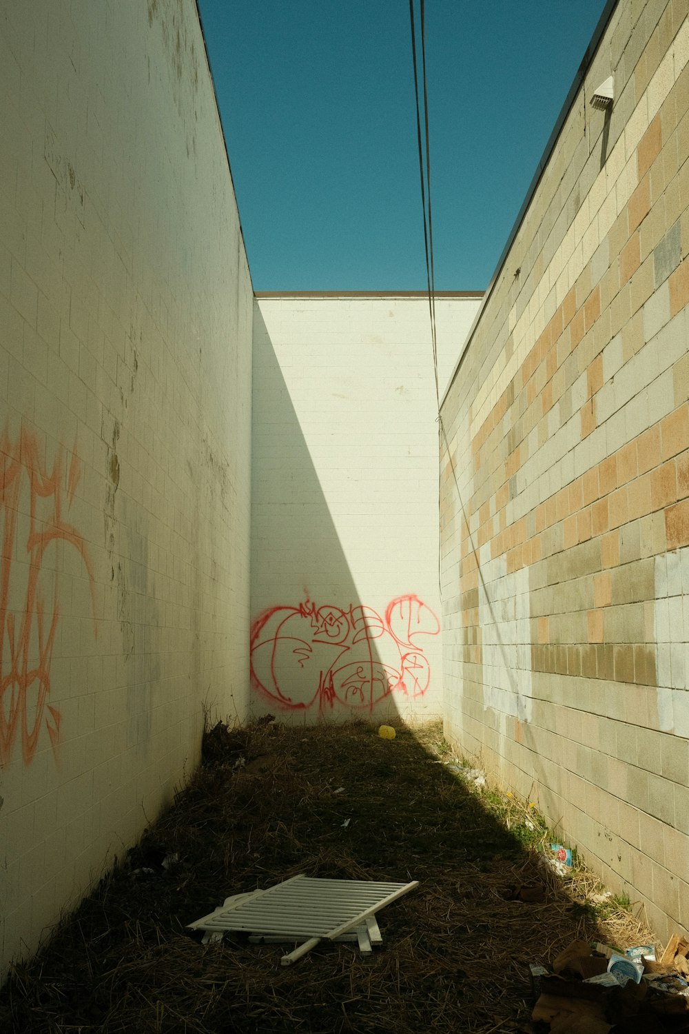 a wall with graffiti on it next to a building