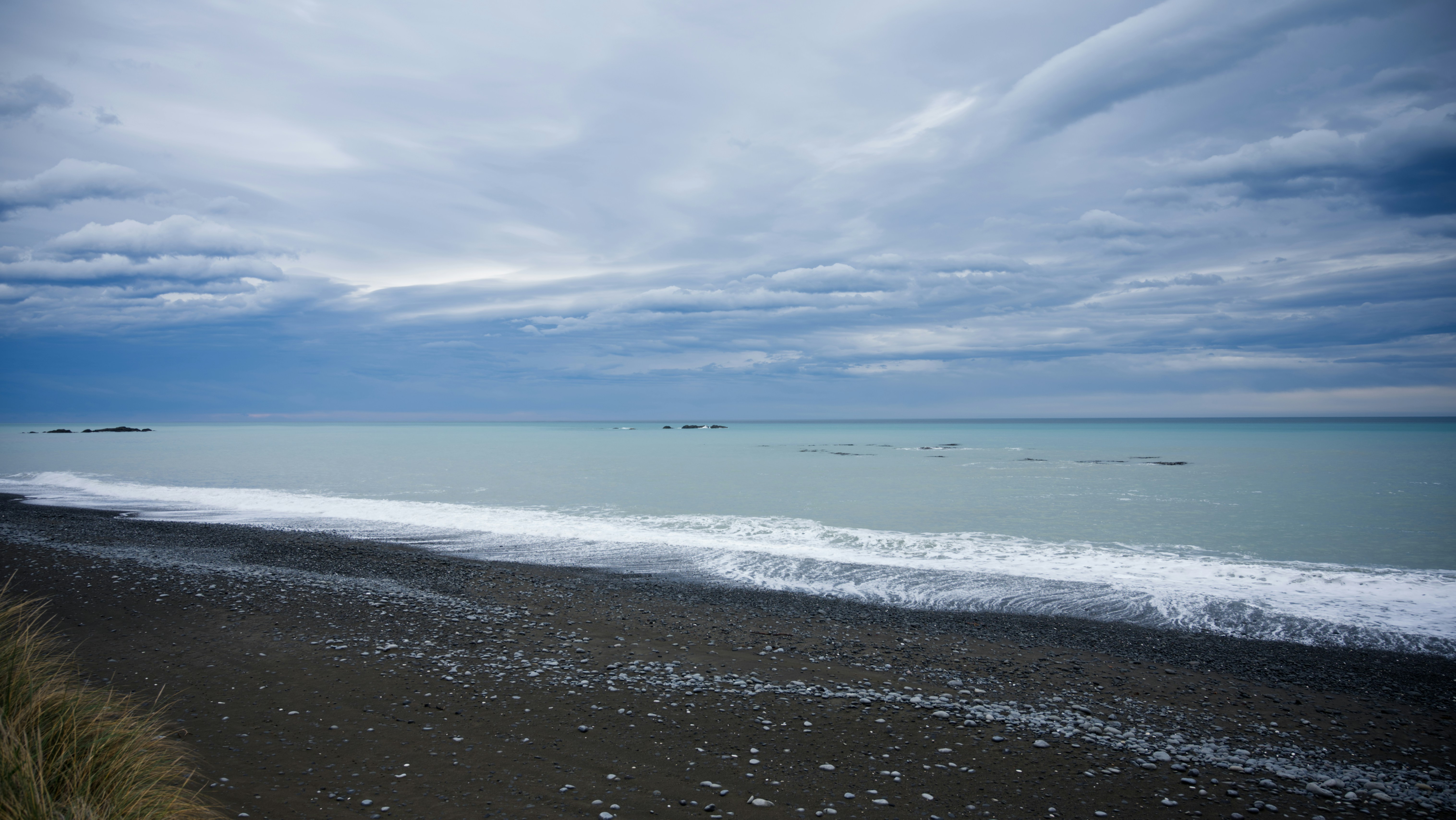 a view of the ocean from the shore of a beach