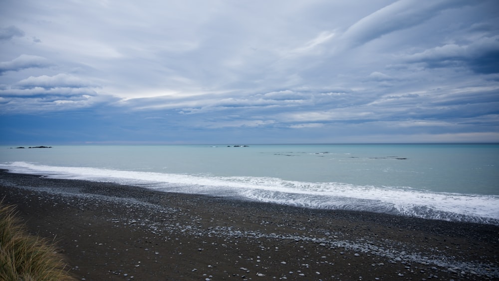 a view of the ocean from the shore of a beach