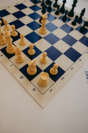 a close up of a chess board with pieces on it