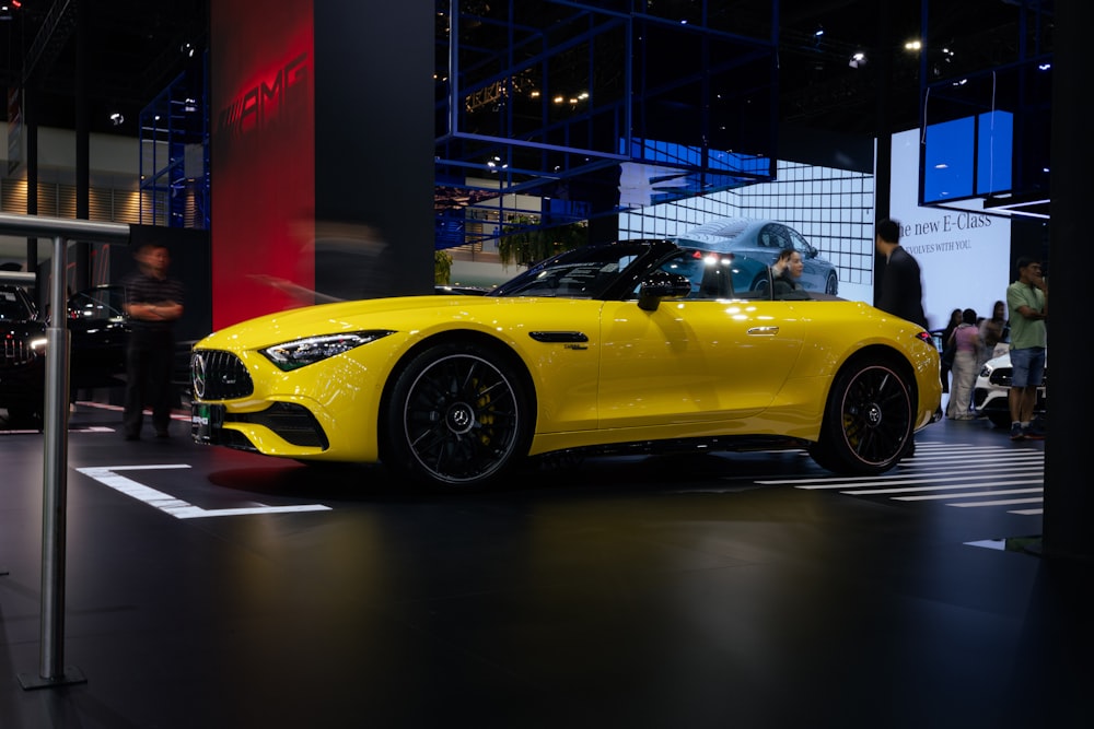 a yellow sports car on display at a car show