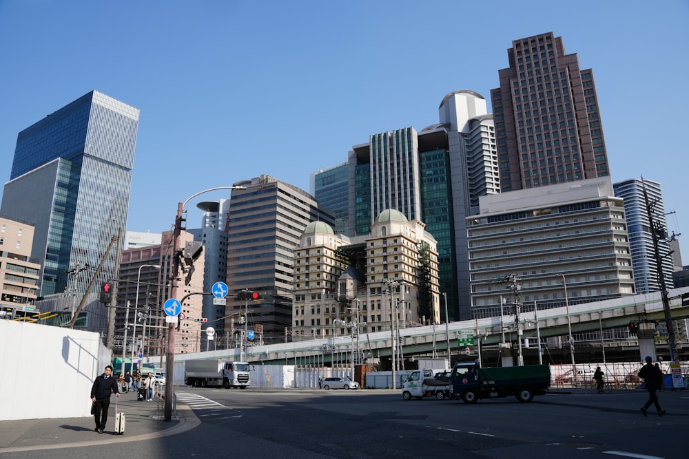 a busy city street with tall buildings in the background