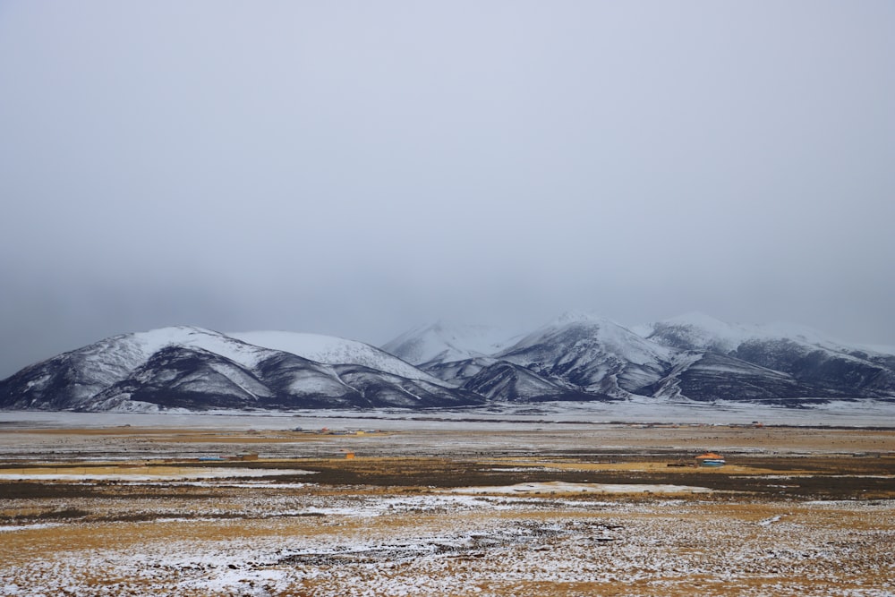 a snow covered mountain range in the distance