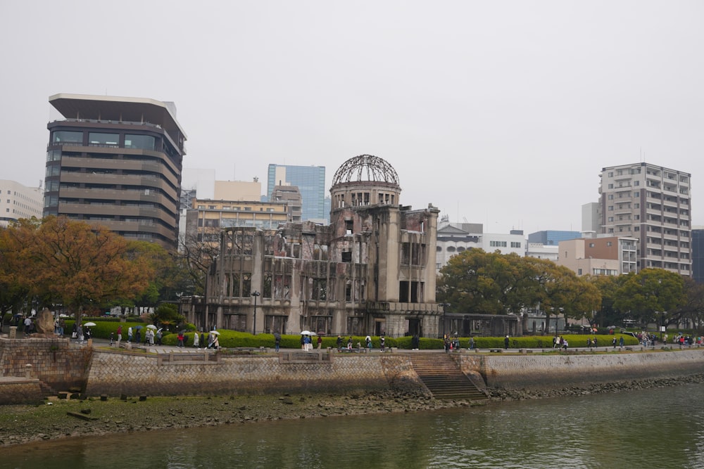 a large building sitting on the side of a river