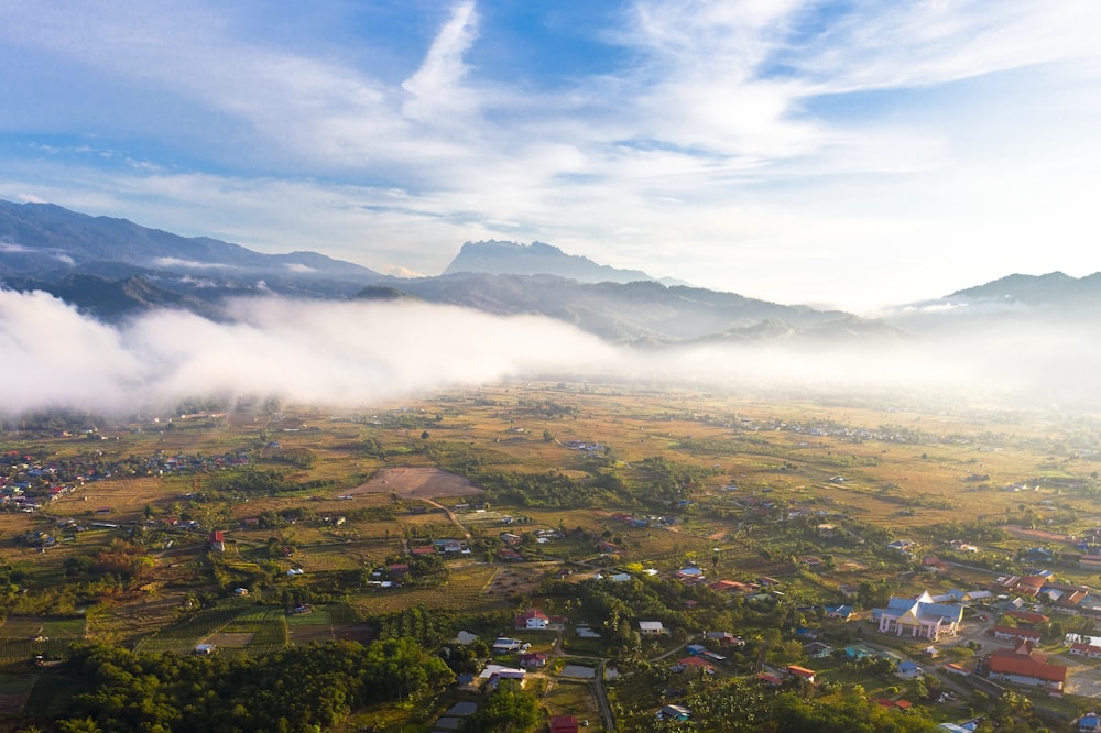 an aerial view of a town surrounded by mountains