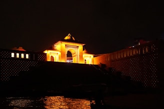 a clock tower lit up in the night sky