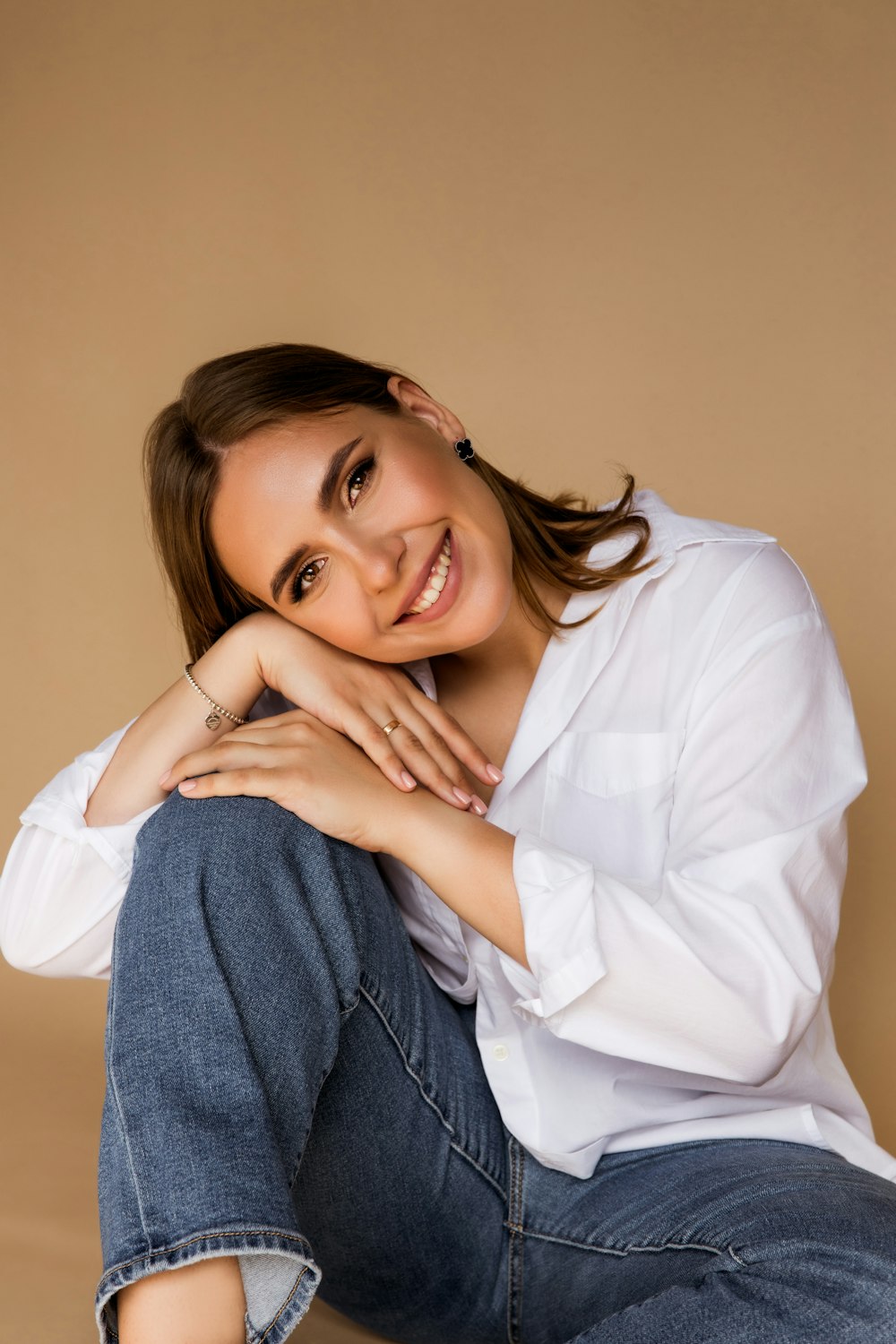 a woman sitting on the ground with her arms crossed