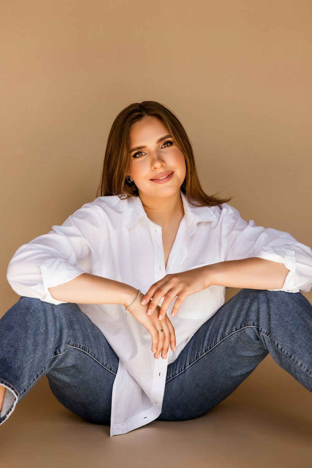 a woman sitting on the ground with her legs crossed