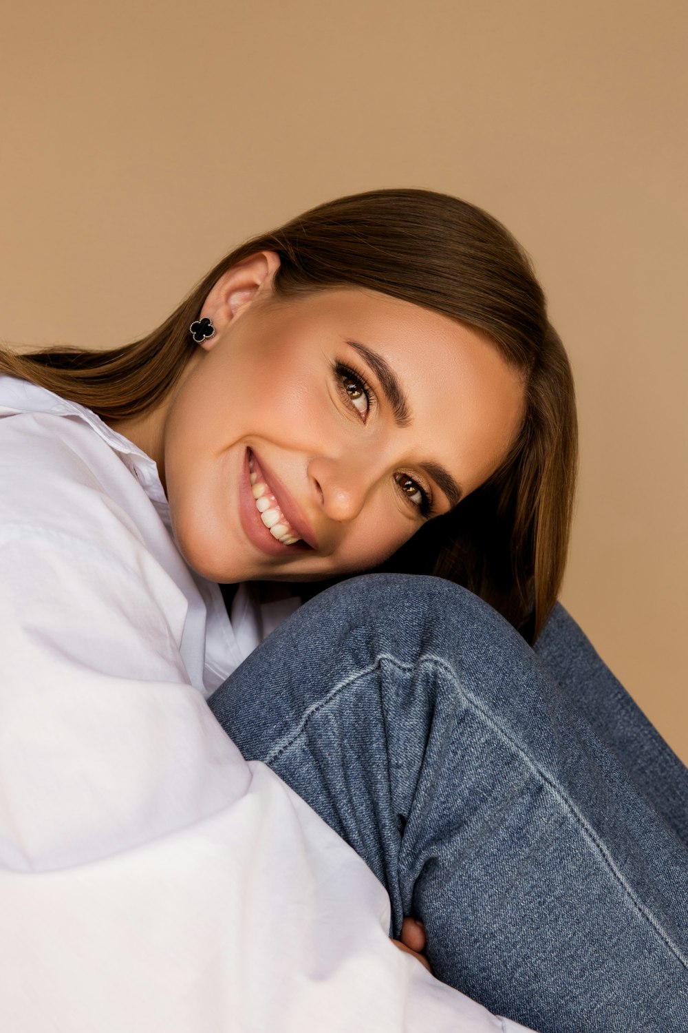 a woman is smiling while laying on her stomach