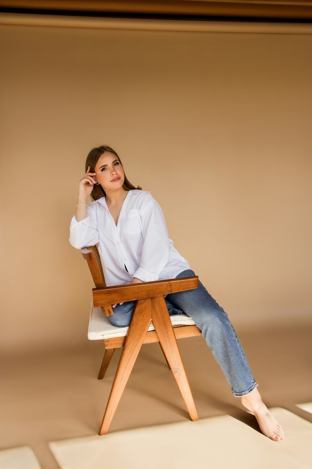 a woman sitting on a chair with her legs crossed