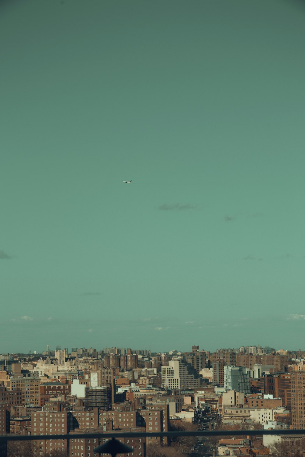 an airplane flying over a city with tall buildings