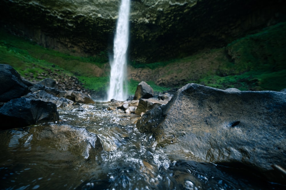 a small waterfall in the middle of some rocks