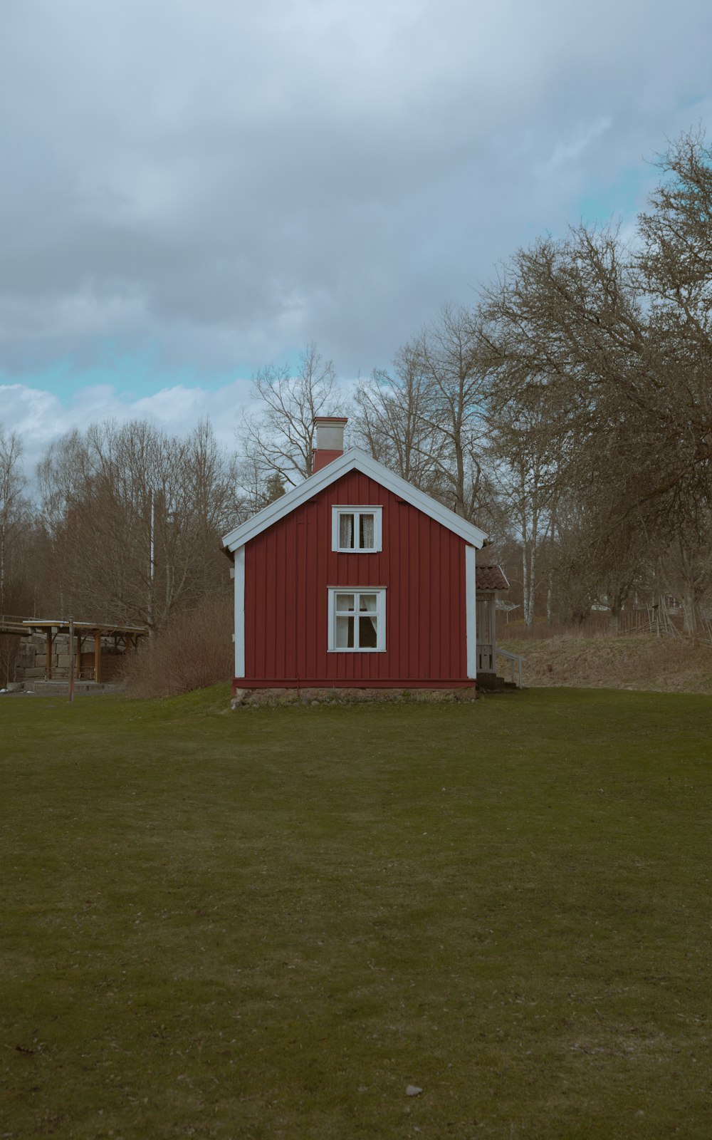 a red house with a white roof and windows