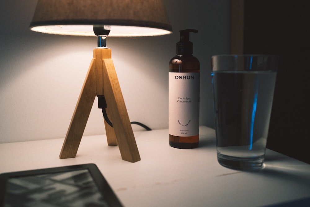 a table with a tablet and a lamp on it