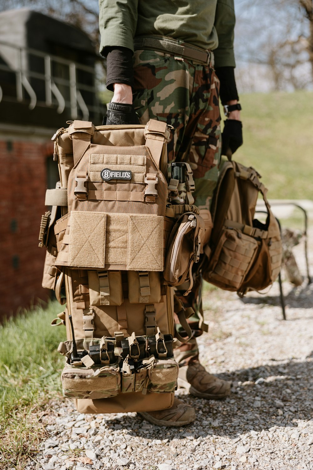 a man in camouflage carrying a large bag