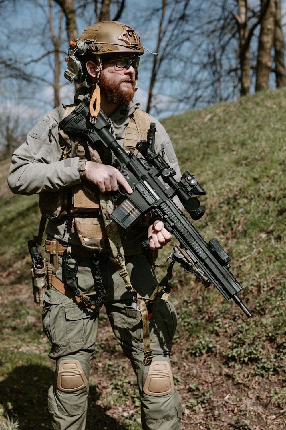 a man with a beard holding a rifle