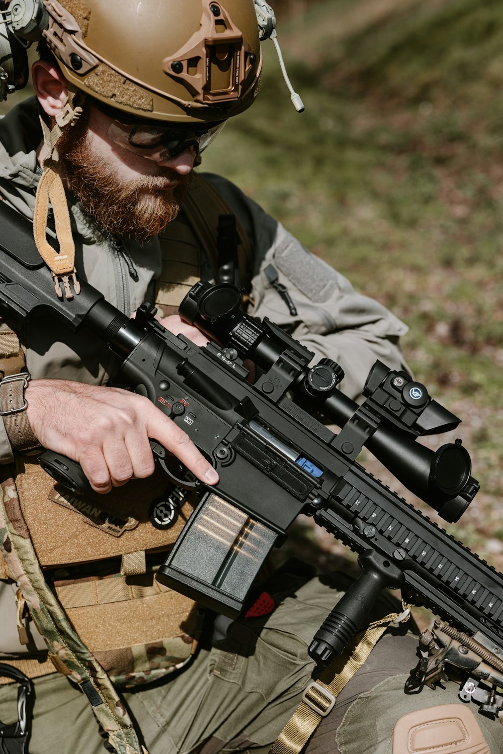 a man with a beard holding a rifle