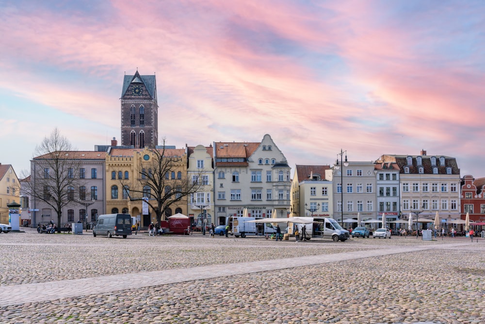 a row of buildings with a clock tower in the background