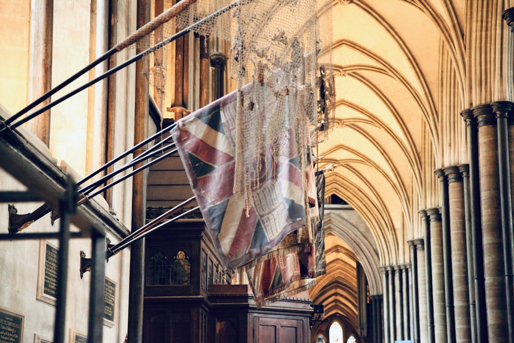 a flag hanging from the ceiling of a cathedral