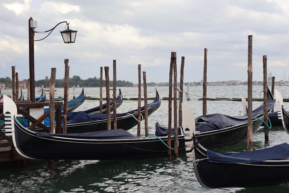 a bunch of gondolas that are sitting in the water