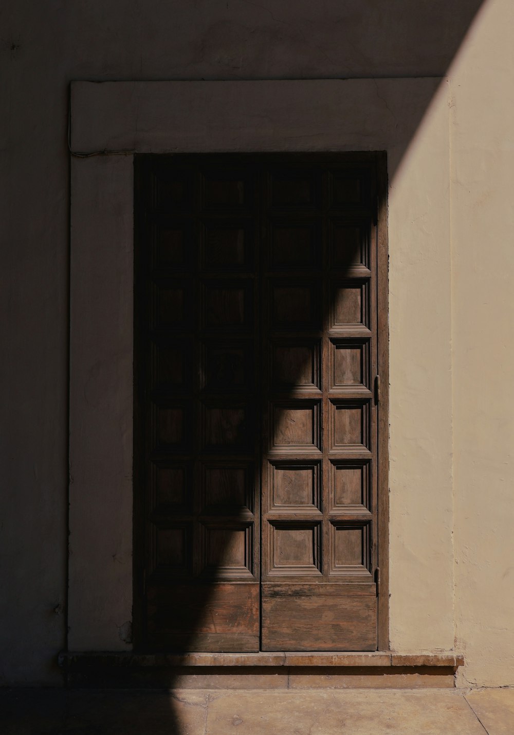 the shadow of a person standing in front of a door