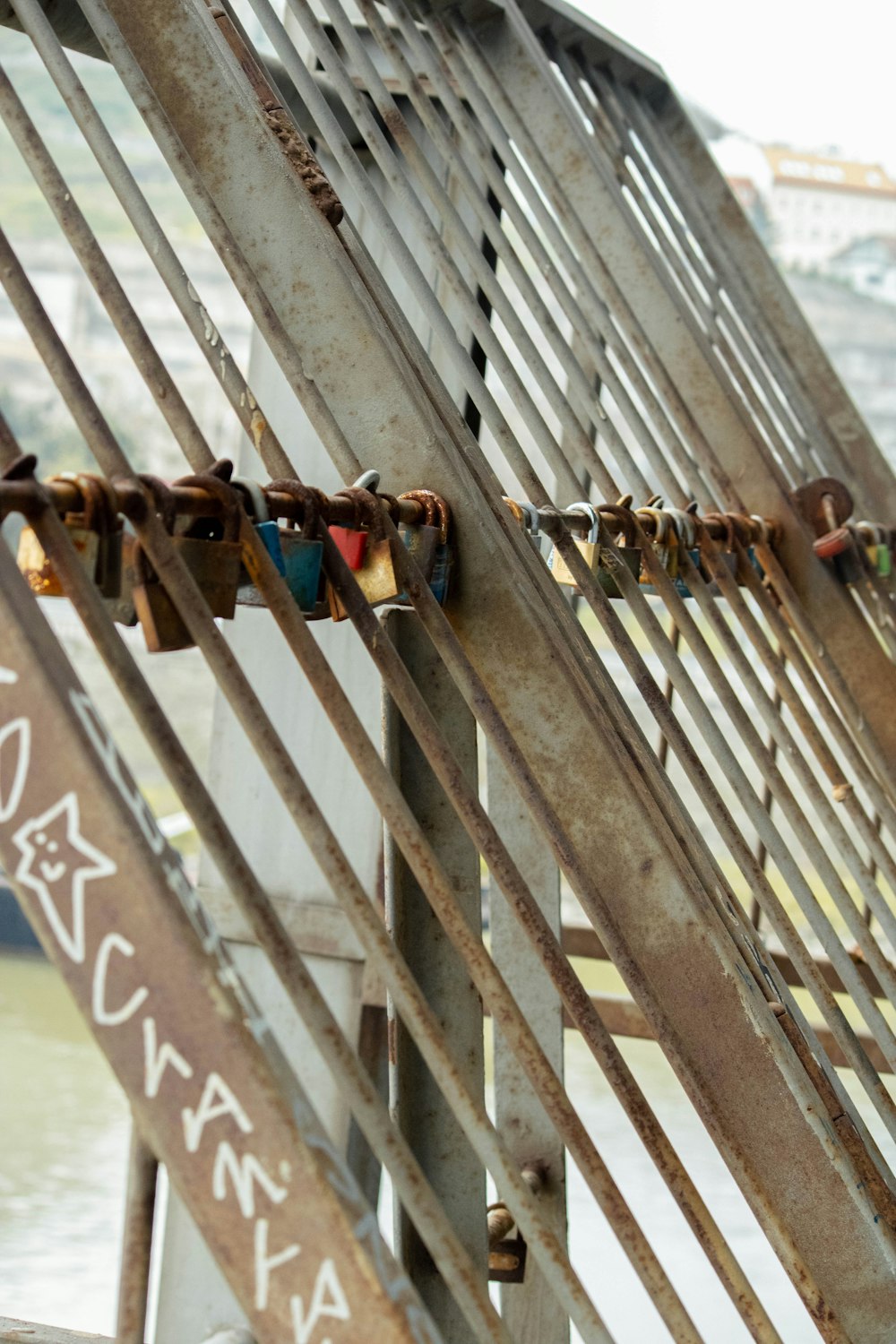 a bunch of locks are attached to a fence