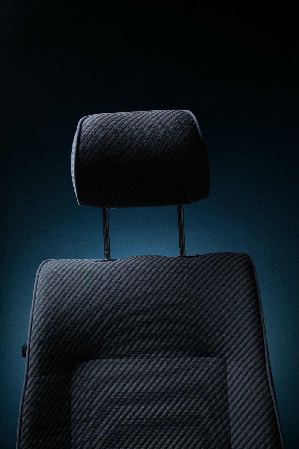 a black piece of luggage sitting on top of a chair