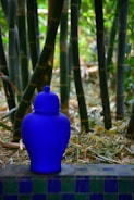 a blue vase sitting on top of a tiled bench