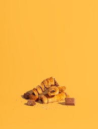 a pile of croissants sitting on top of a yellow surface