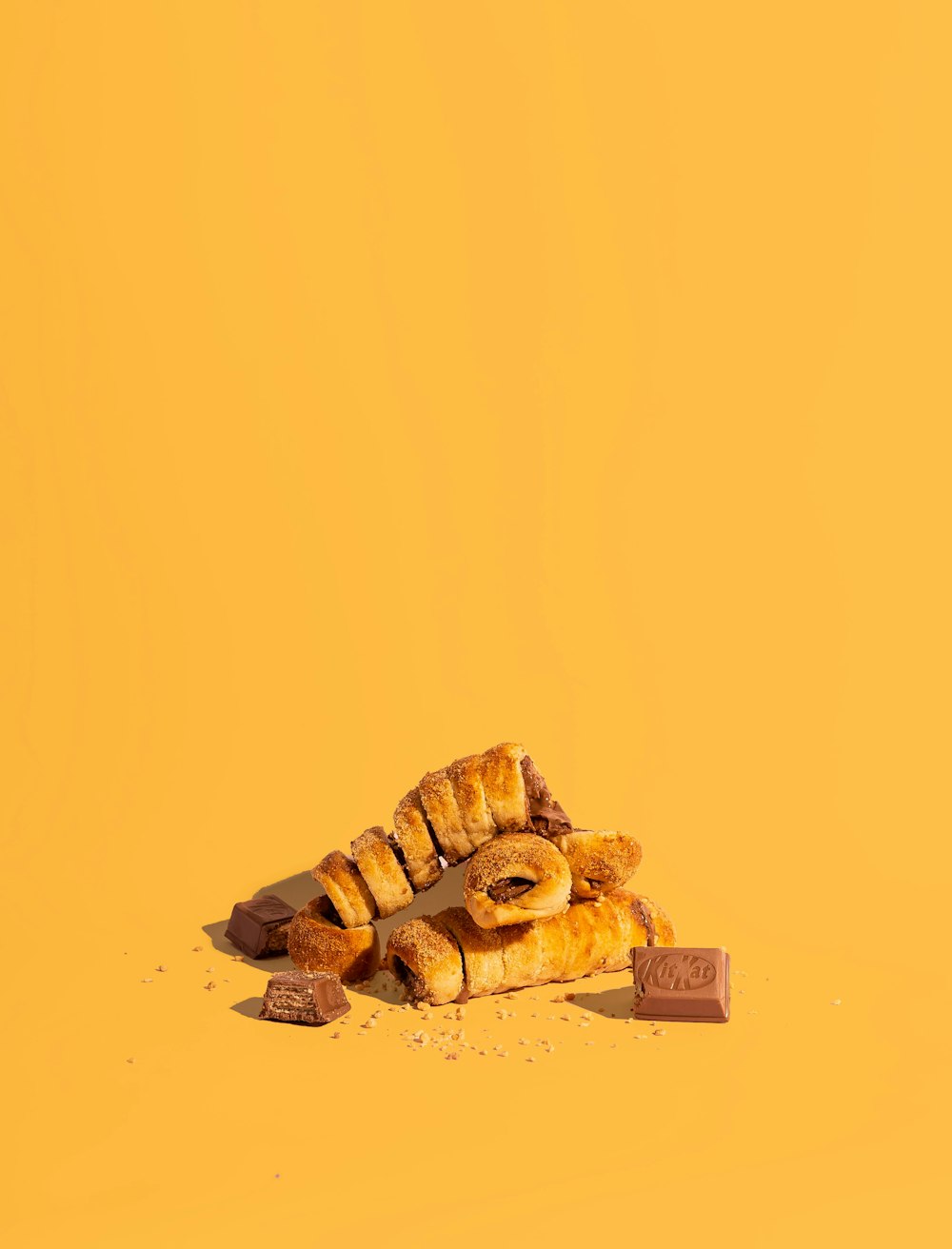 a pile of croissants sitting on top of a yellow surface