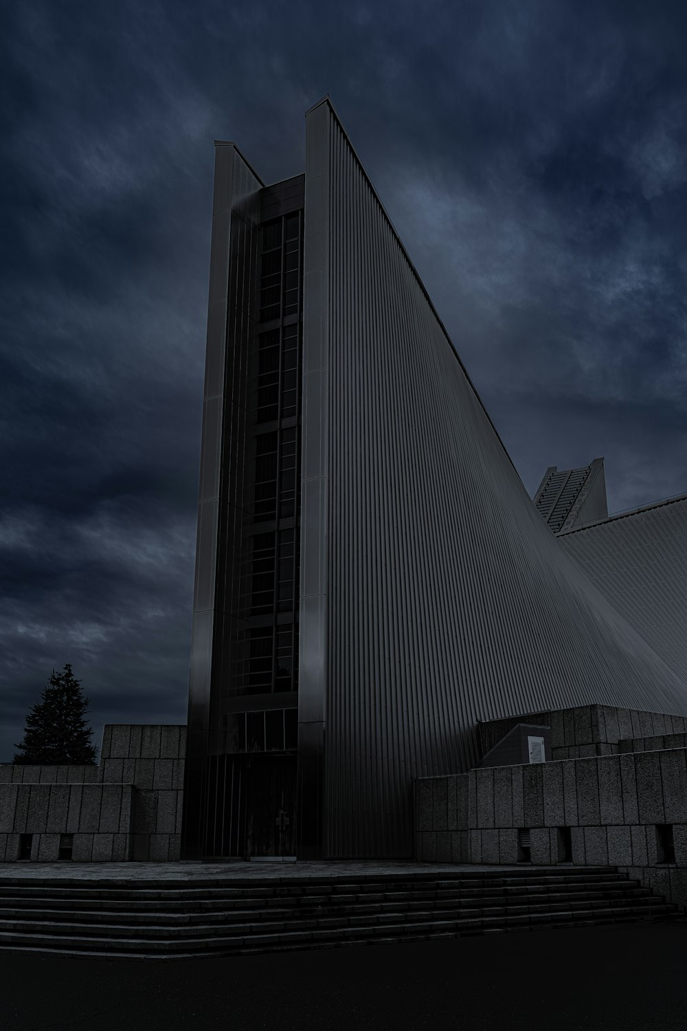 a very tall building sitting under a cloudy sky