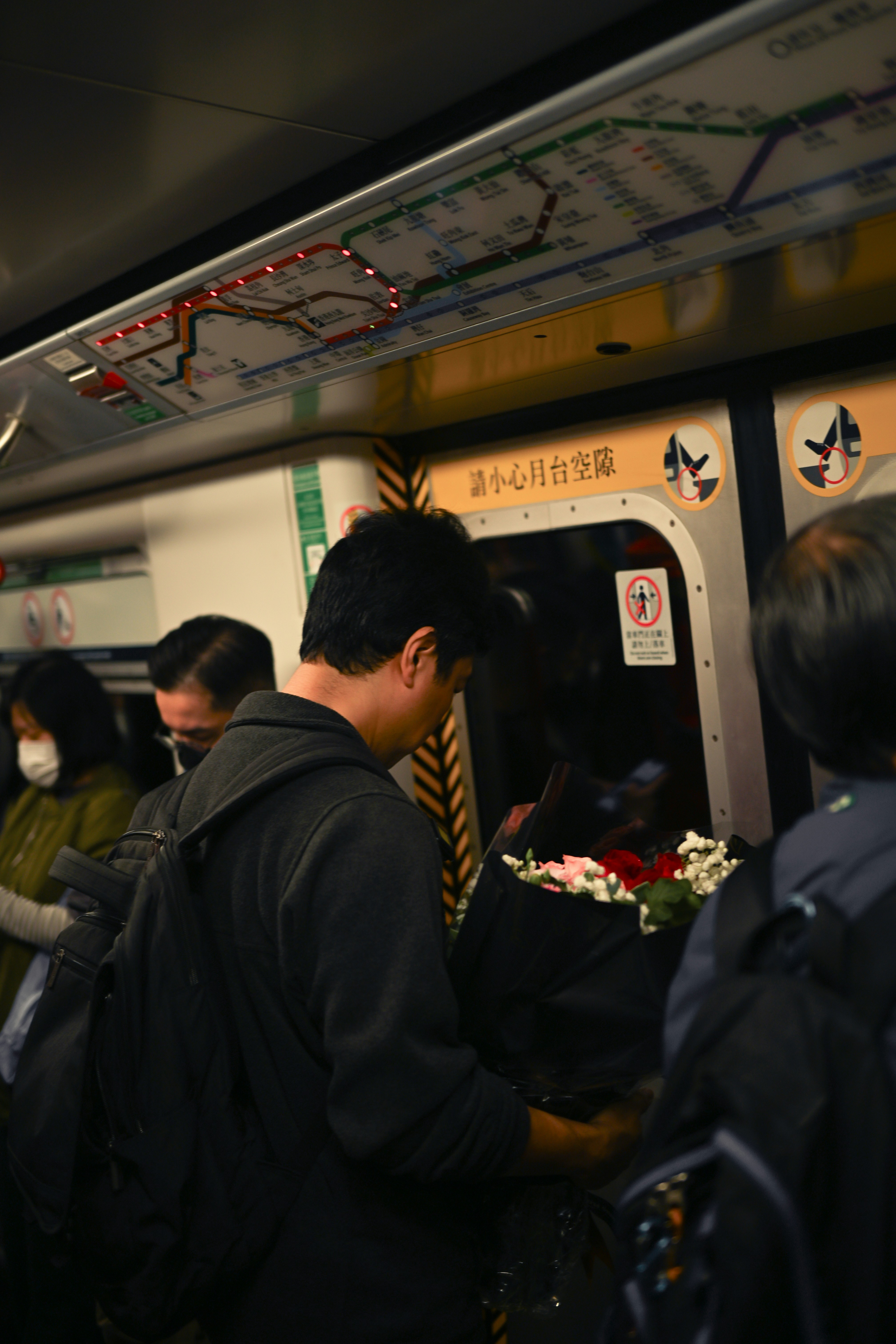 a group of people standing next to each other on a train