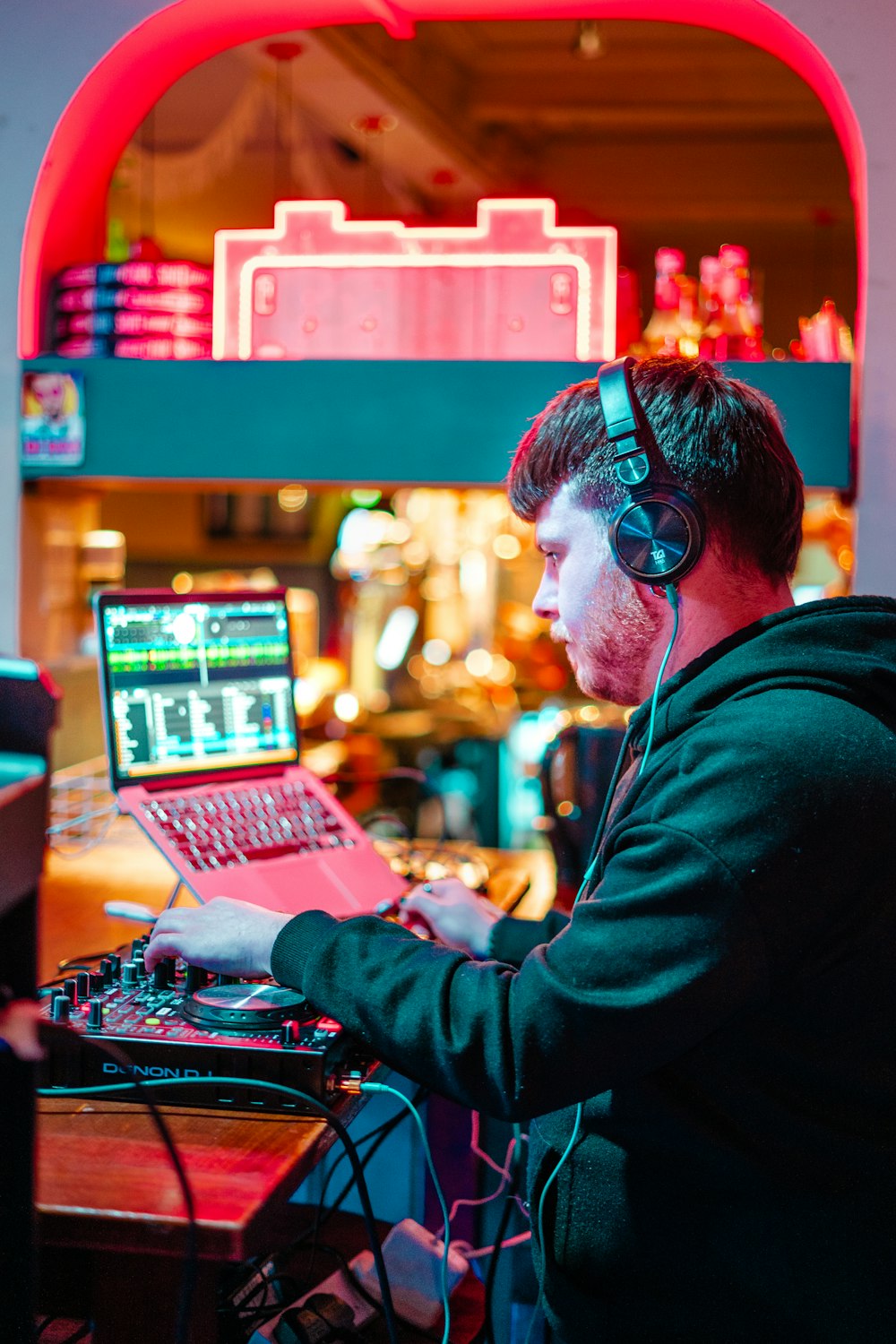 a man sitting at a desk with a laptop and headphones on