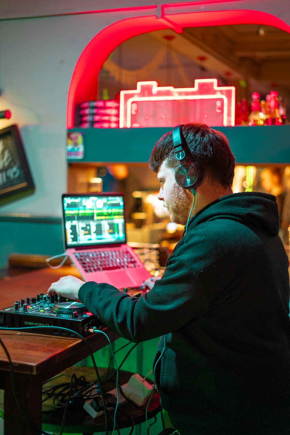 a man sitting at a desk with a laptop and headphones