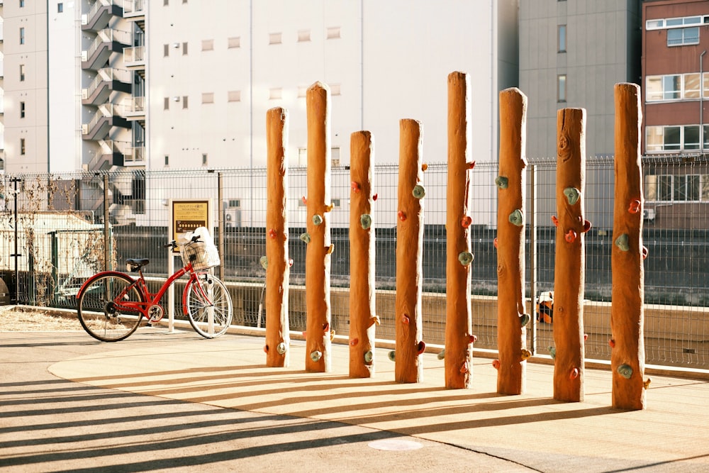 a bike parked next to a tall wooden structure