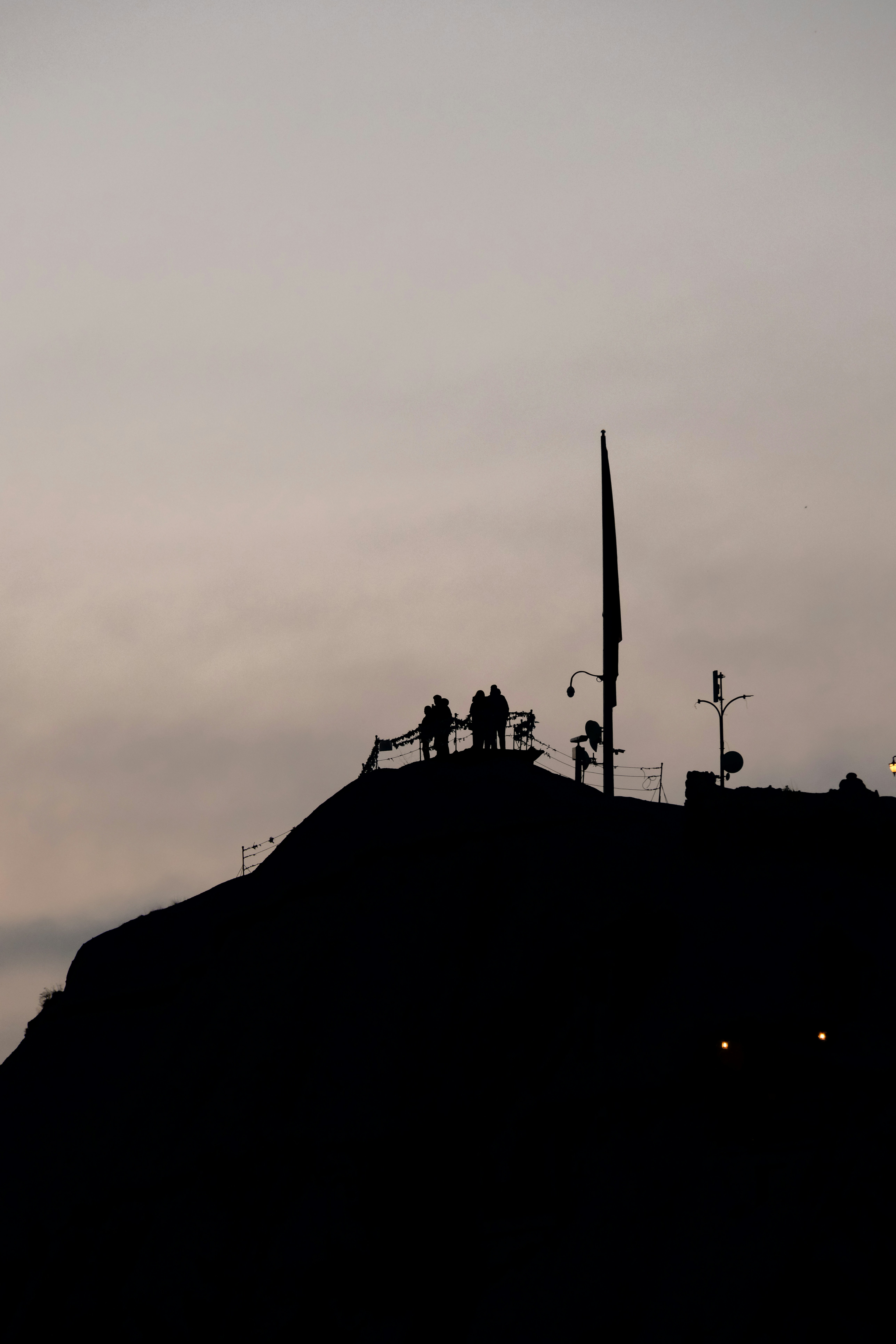 a hill with a clock tower on top of it - a-hill-with-a-clock-tower-on-top-of-it-ETfrqkS02rg