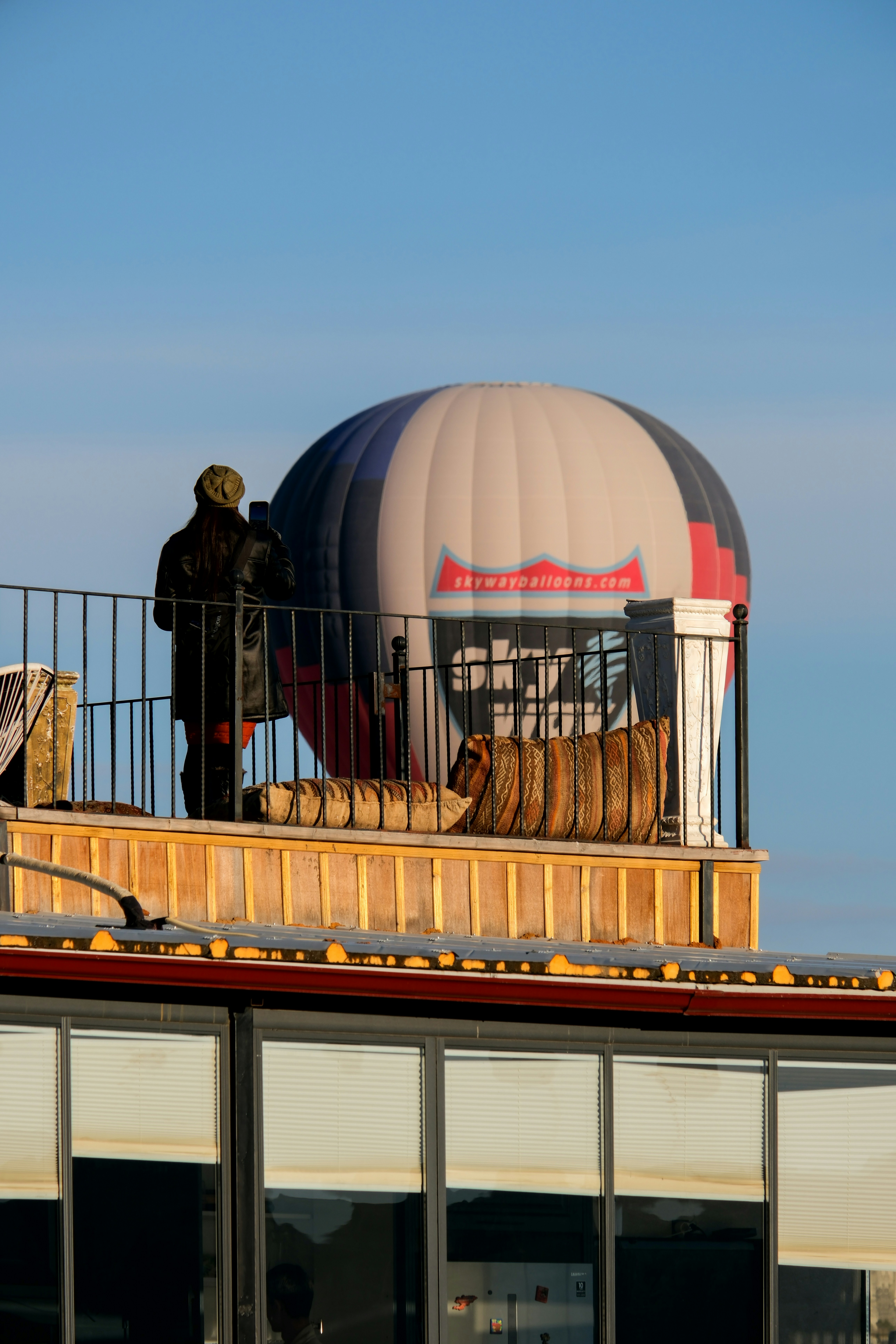 a hot air balloon sitting on top of a building - a-hot-air-balloon-sitting-on-top-of-a-building-IG4QCfDLouo