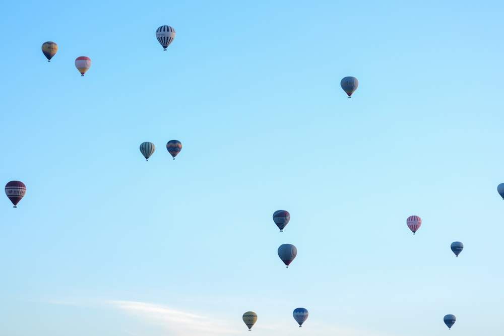 a group of hot air balloons flying in the sky