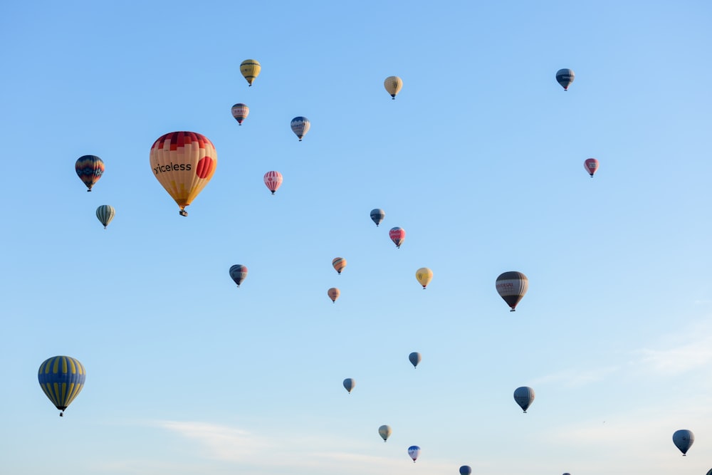 a bunch of hot air balloons flying in the sky