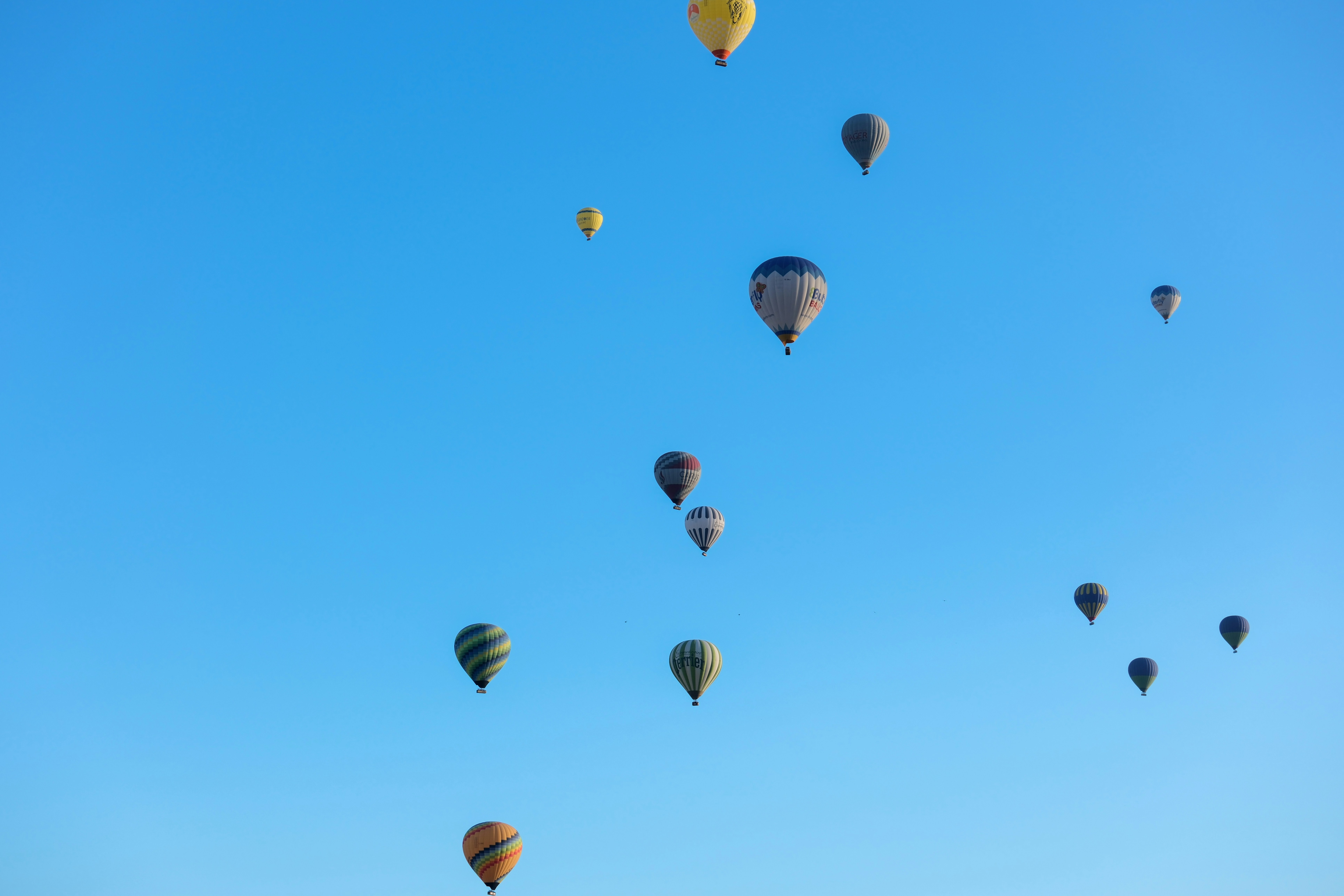 a group of hot air balloons flying in the sky - a-group-of-hot-air-balloons-flying-in-the-sky-7v2jRO660JY