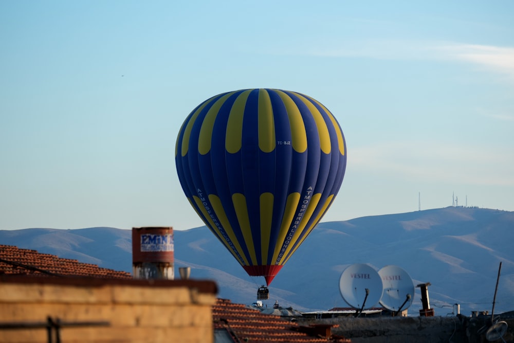 a blue and yellow hot air balloon in the sky