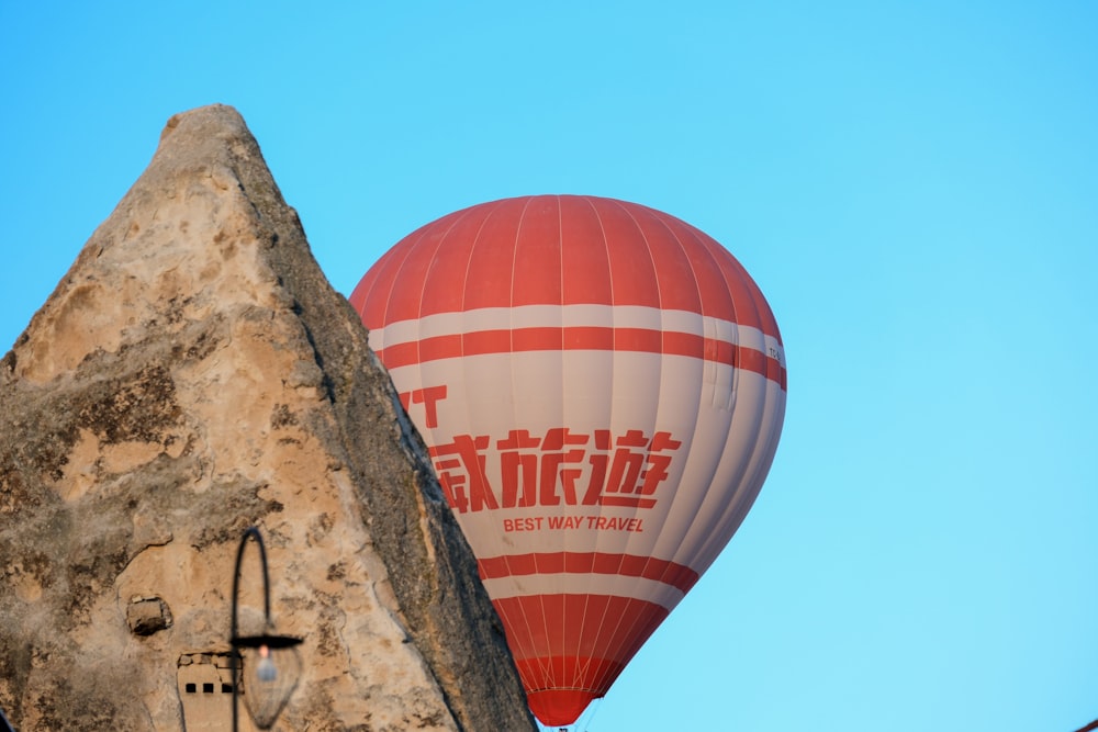 a hot air balloon flying over a stone building