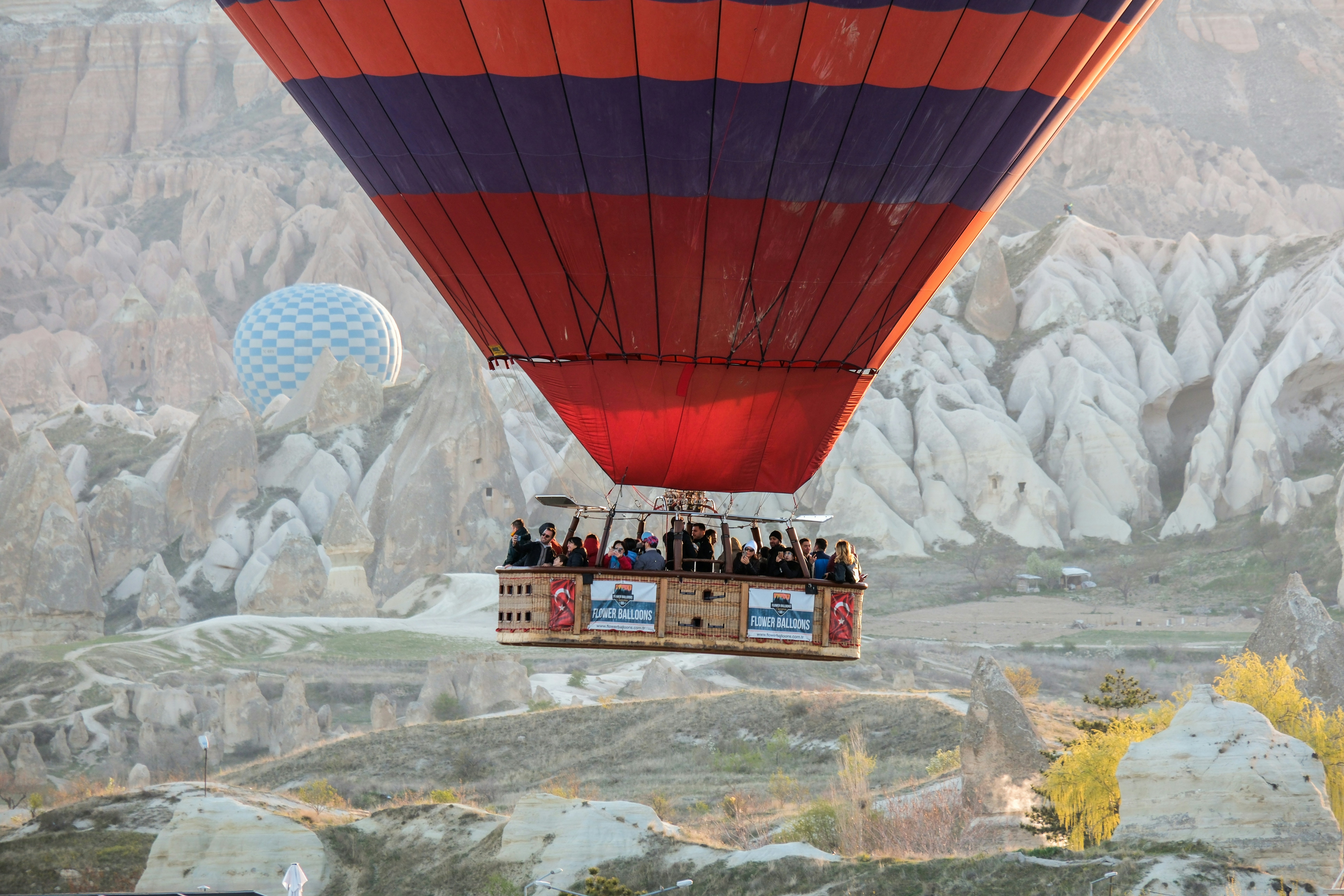a group of people riding in a hot air balloon - a-group-of-people-riding-in-a-hot-air-balloon-kopkYhgy0i8