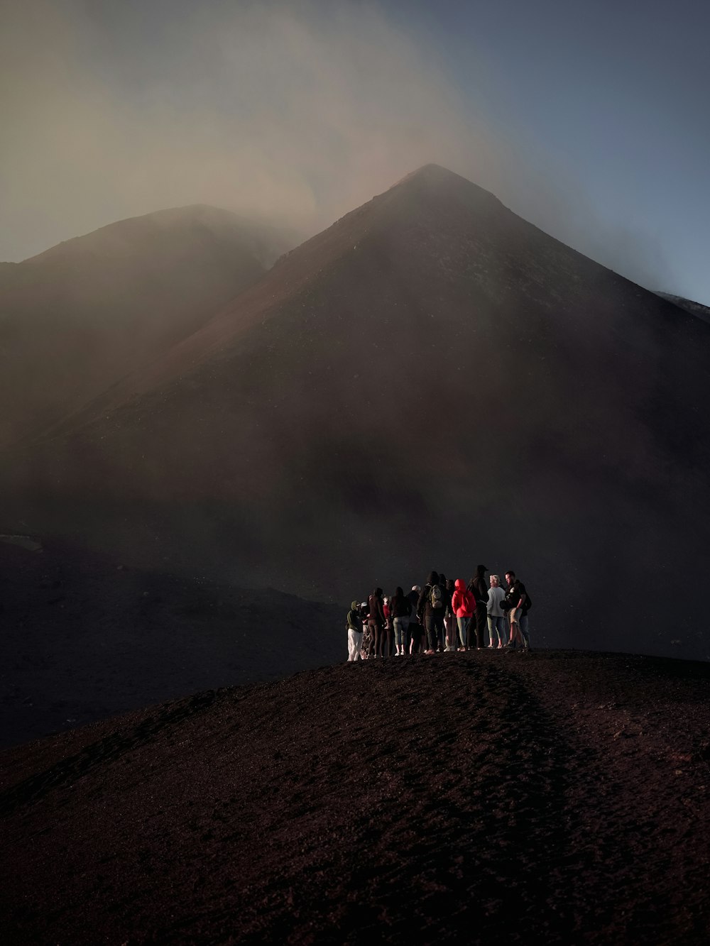 a group of people standing on top of a hill