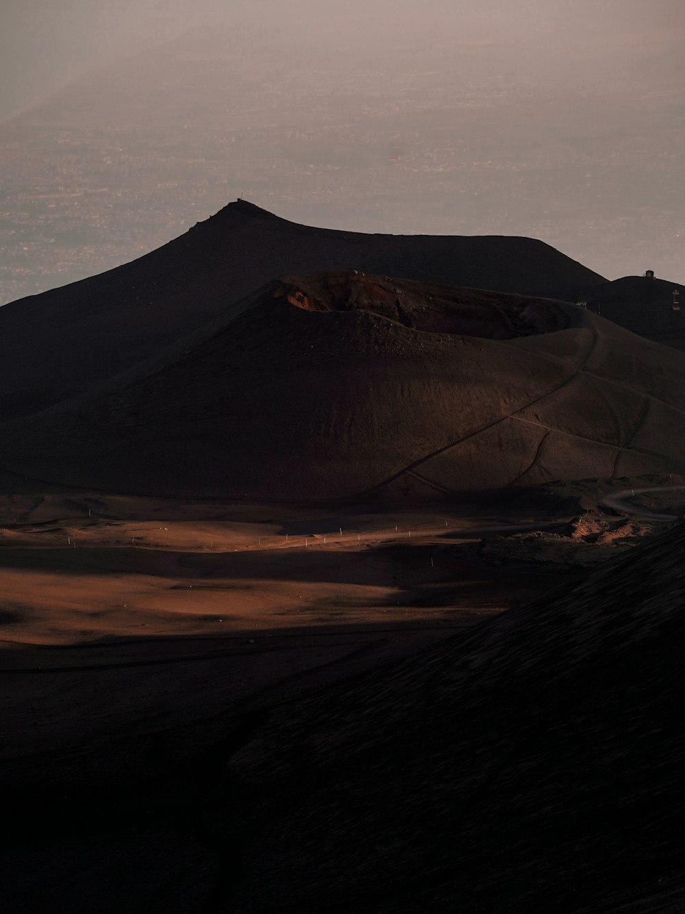 a mountain with a few hills in the background