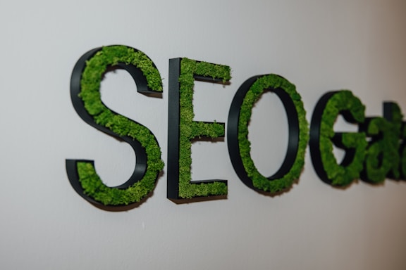 A close up of a sign with grass on it. SEO. Search Engine Optimization