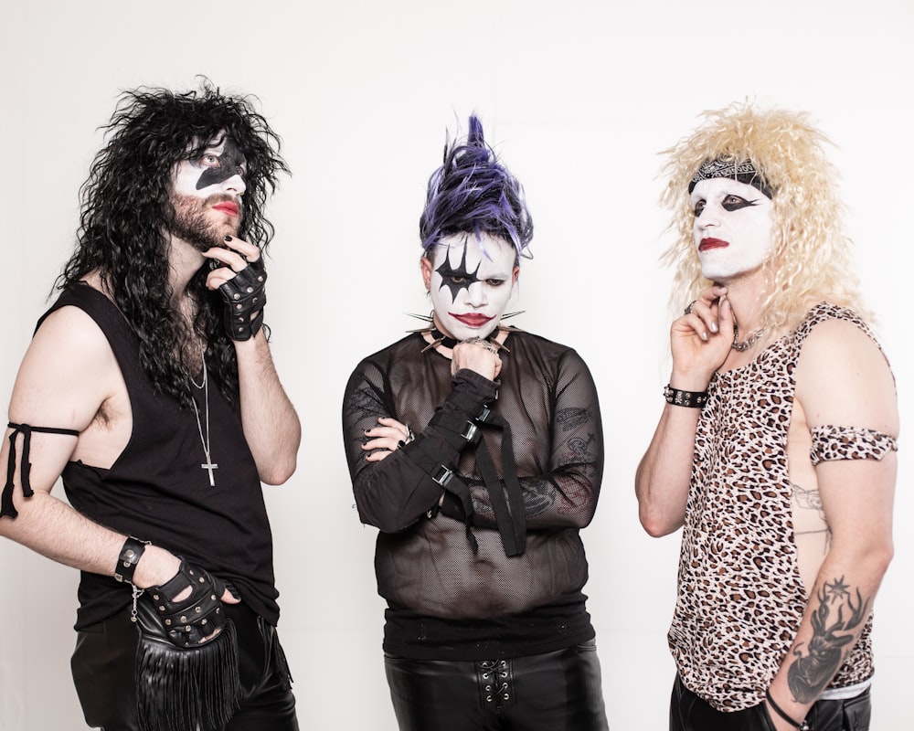 a group of three men with makeup on their faces