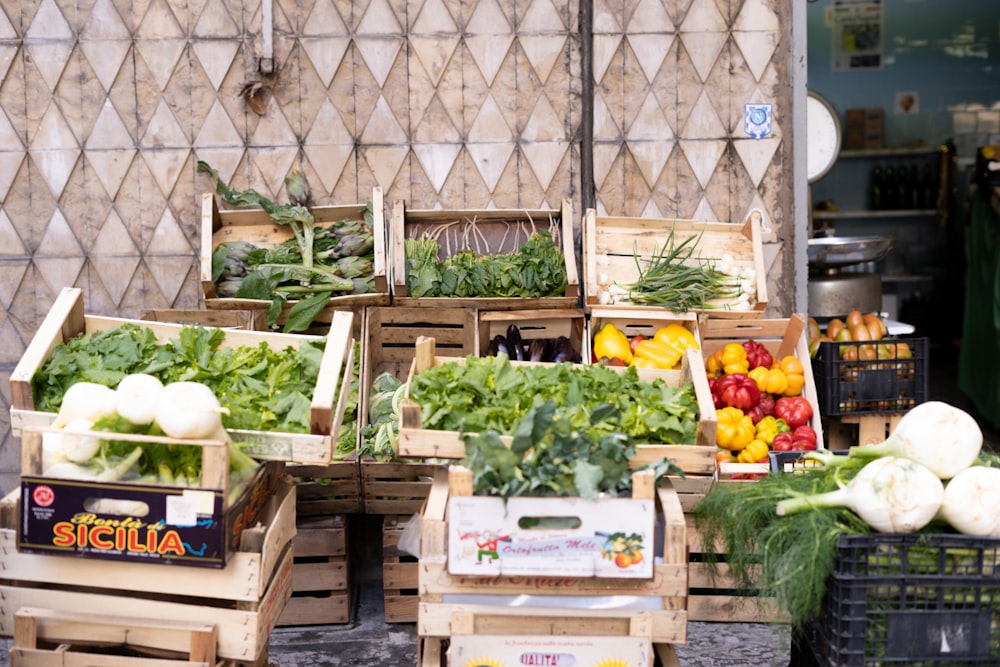 a bunch of crates filled with different types of vegetables