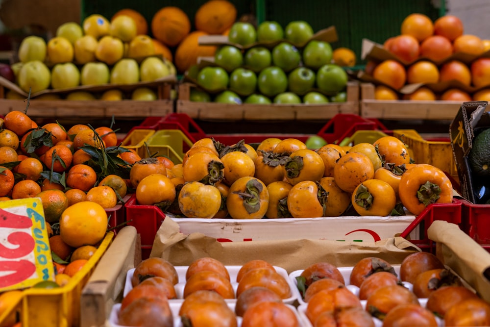 a fruit stand with oranges, apples, and other fruits